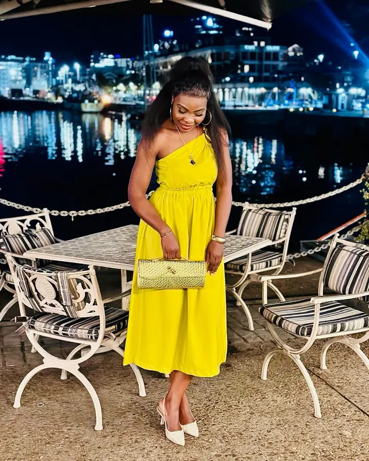 Colette in a yellow dress at the Waterfront at night